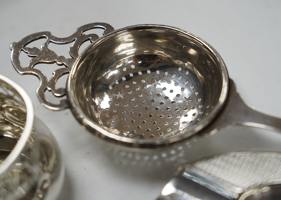 Sundry small silver and white metal items including silver tea strainer on stand and ashtray, pierced silver bowl, sterling dishes and dwarf candlesticks, etc. Condition - poor to fair